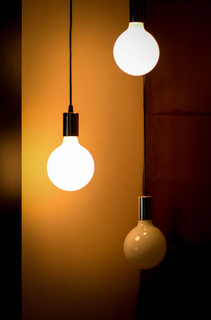 about-02 Composition of three glowing light bulbs creating a warm ambiance. Ideal for energy and design themes.